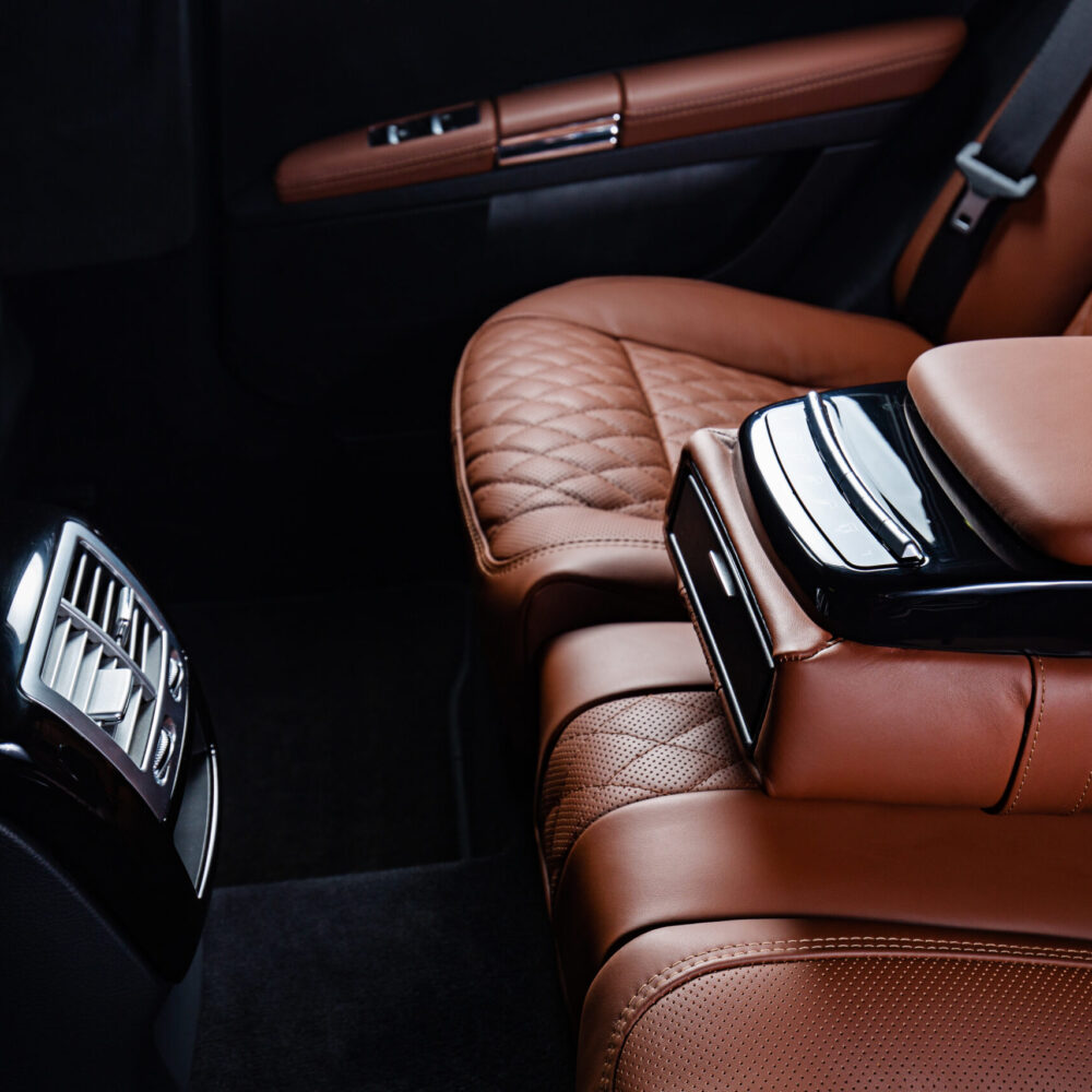 A luxury car interior in brown and black colors