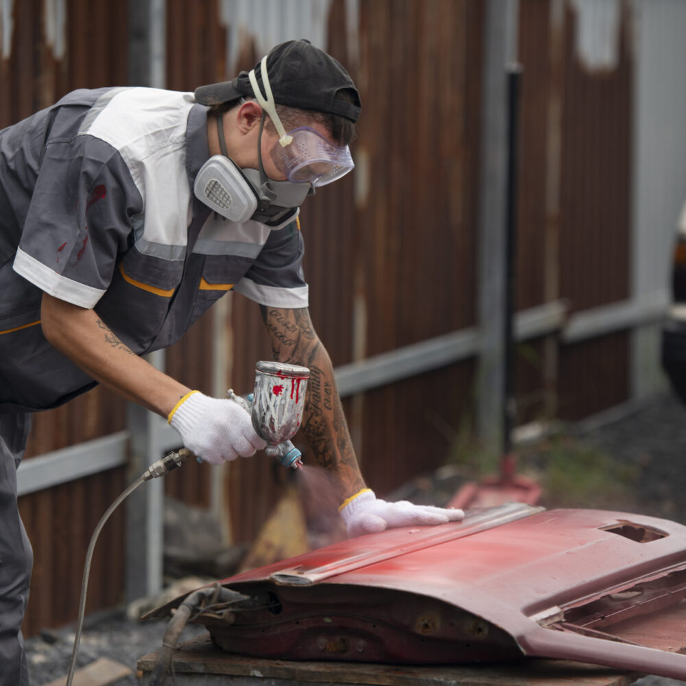 man-painting-car-door-side-view