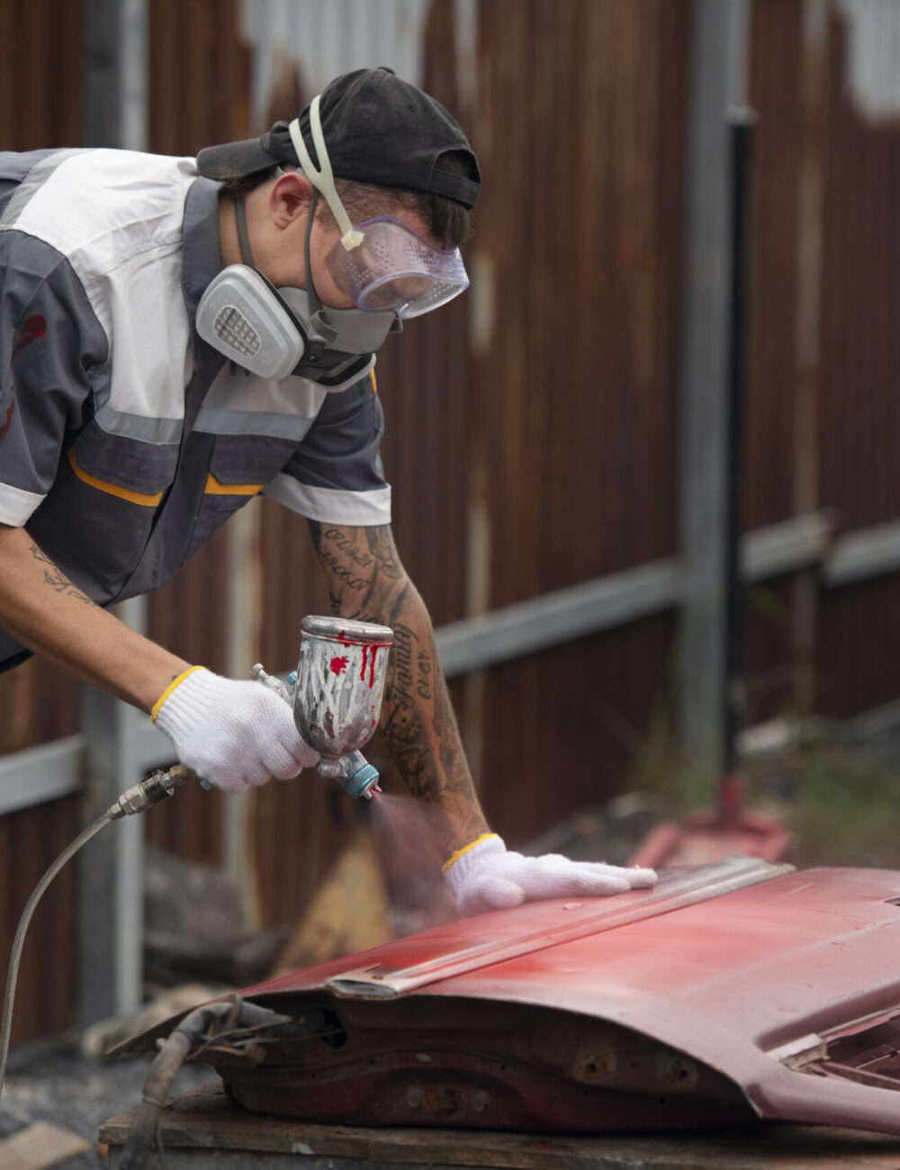 man-painting-car-door-side-view